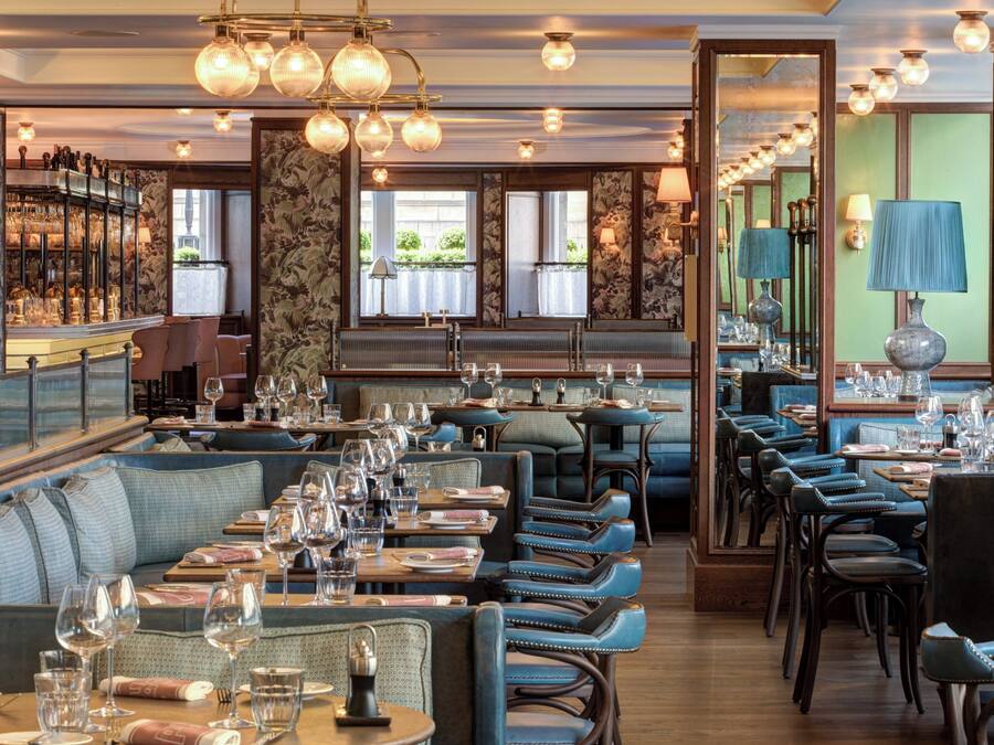 Un restaurant doté d’un bar, d’un espace pour s’asseoir et d’une vue sur l’extérieur.