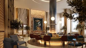 A modern lobby with a central seating area, a large mural, and a distinctive cylindrical light fixture.