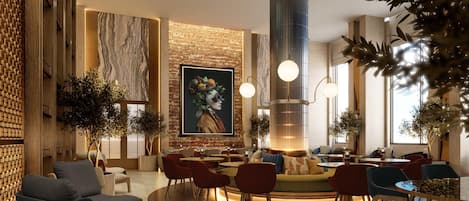 Un vestíbulo moderno con una zona de estar central, un mural grande y una lámpara cilíndrica distintiva.