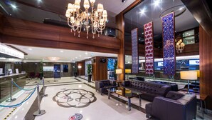 A spacious lobby with a chandelier, seating area, and decorative panels. - Radisson Hotel President Old Town Istanbul (Istanbul)