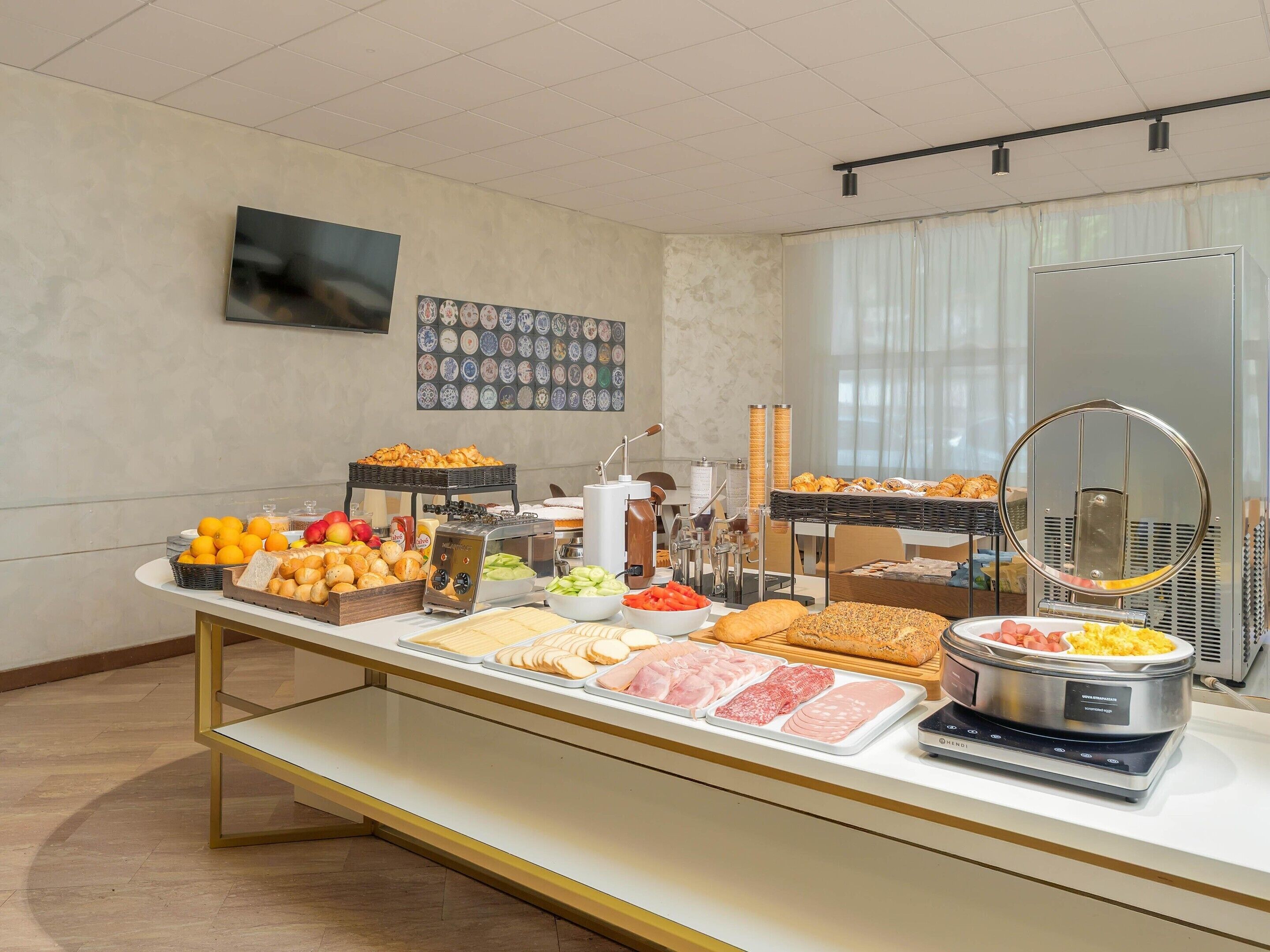 A buffet with various food items and a self-service coffee station.