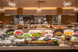A buffet with various food items and a chef in the background. - ART HOTEL NARITA (Narita)