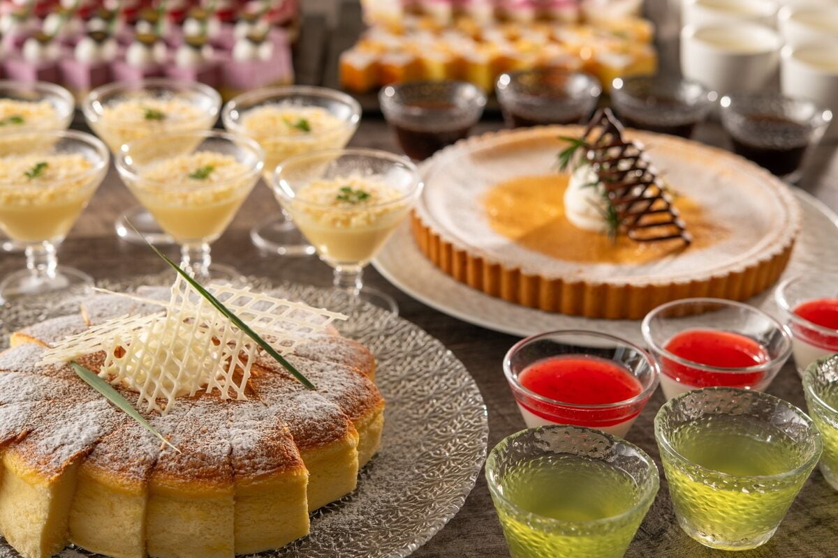 A dessert table with various sweets and drinks.