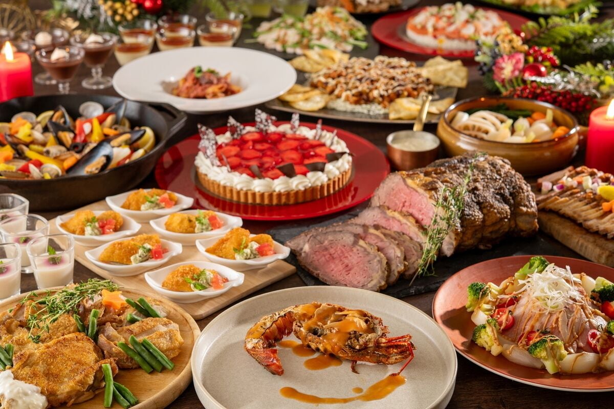 A variety of dishes including seafood, a steak, and a dessert on a table.