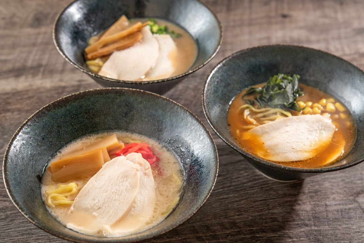 Three bowls of soup with different ingredients.