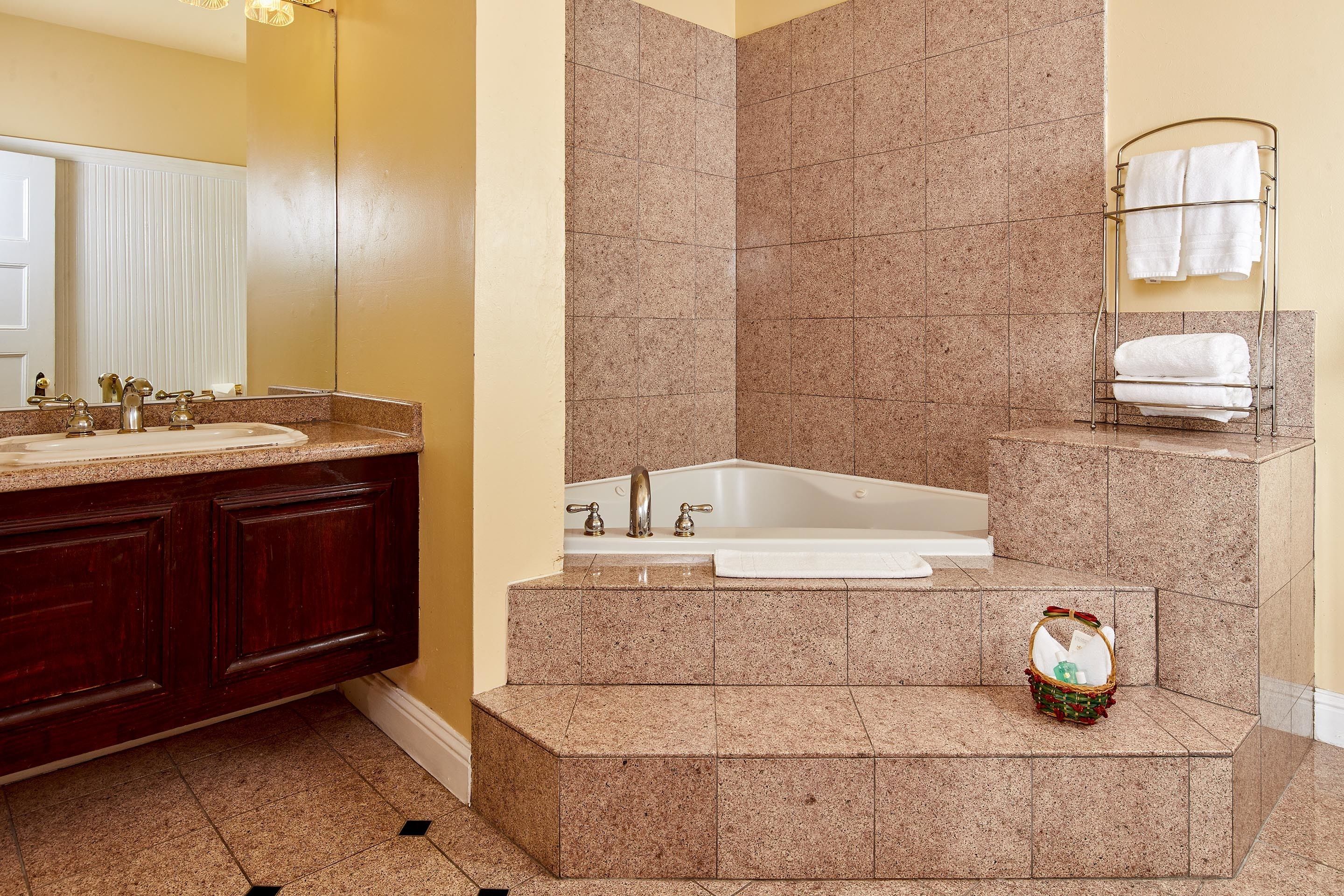 combined shower/bathtub, designer toiletries, hair dryer, towels