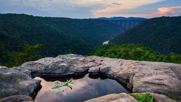 A rocky landscape with a bridge in the distance.