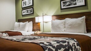 A hotel room with two beds, a nightstand, a lamp, and framed pictures on the wall. - Sleep Inn Summersville - New River Gorge Area (Summersville)