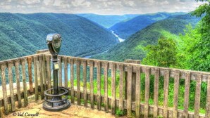 A wooden observation deck with a vintage telescope, overlooking a lush valley with a river. - Sleep Inn Summersville - New River Gorge Area (Summersville)
