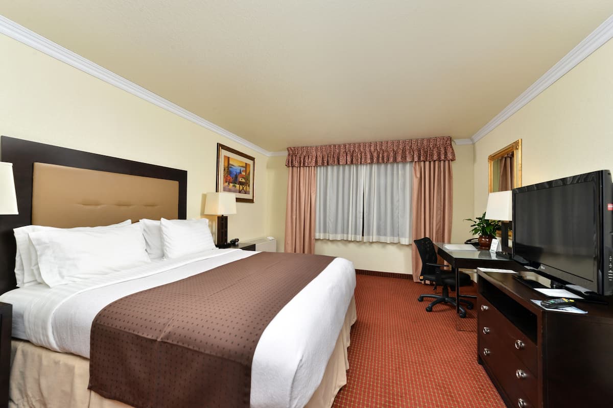 Premium bedding, desk, laptop workspace, iron/ironing board
