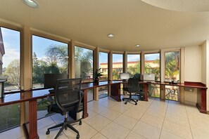 A spacious office with large windows, two desks with computers, and office chairs. - Holiday Inn Rancho Cordova by IHG (Rancho Cordova)