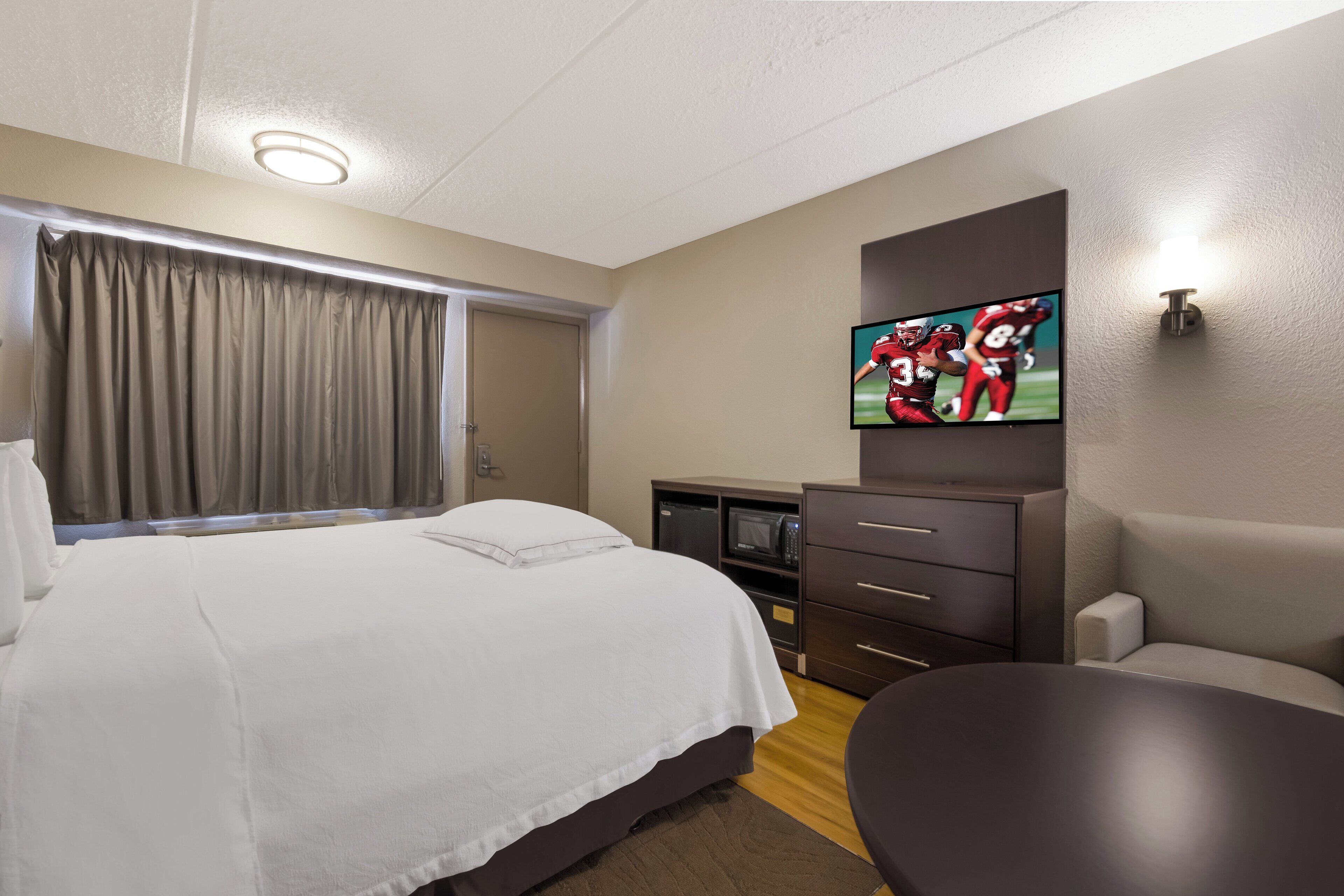 premium room, 1 king bed (upgraded bedding & snack, smoke free) | blackout curtains, iron/ironing board, free wifi, bed sheets