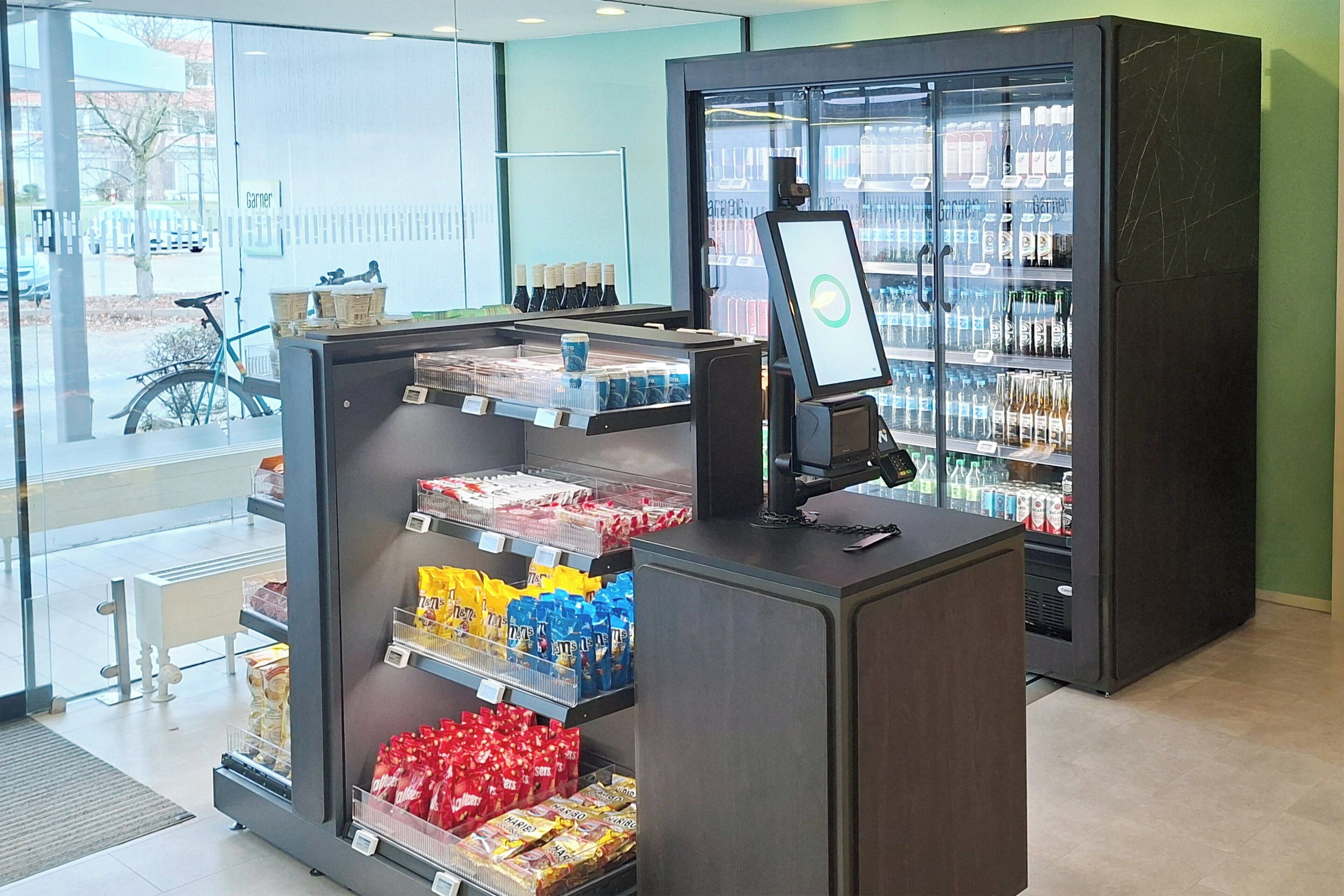 A self-service beverage kiosk with a variety of drinks and snacks.