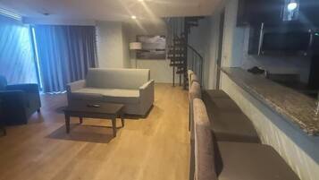 Premium Penthouse, 1 King Bed, Non Smoking, Jetted Tub | Living area | 43-inch flat-screen TV with cable channels