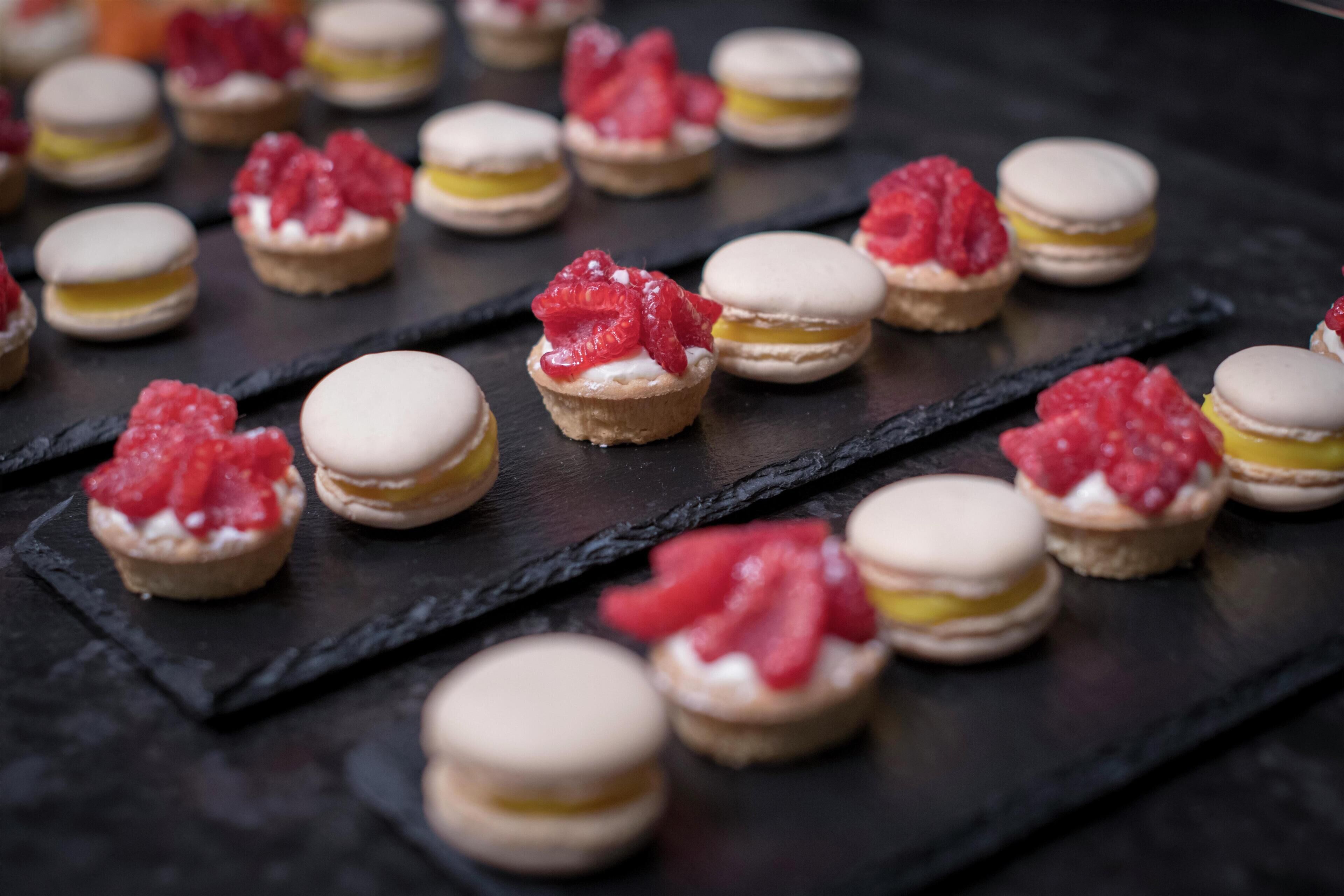 Macarons dispuestos sobre una tabla de pizarra.