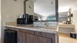 A kitchen with granite countertops, a built-in microwave, and a stainless steel sink. - Best Western Heritage Inn - Chico (Chico)