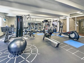A gym with various exercise equipment, including treadmills, weight machines, and an exercise ball. - Mercure Perth (Perth)