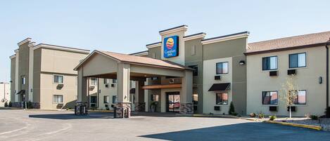 A Comfort Inn hotel with a central entrance, multiple balconies, and a parking lot.