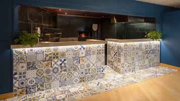 A kitchen with a tiled backsplash, a built-in oven, and a countertop.