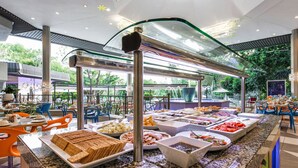 Un espace buffet proposant une variété de plats et différents types de tables et de chaises.