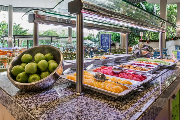 A buffet with various fruits and vegetables.
