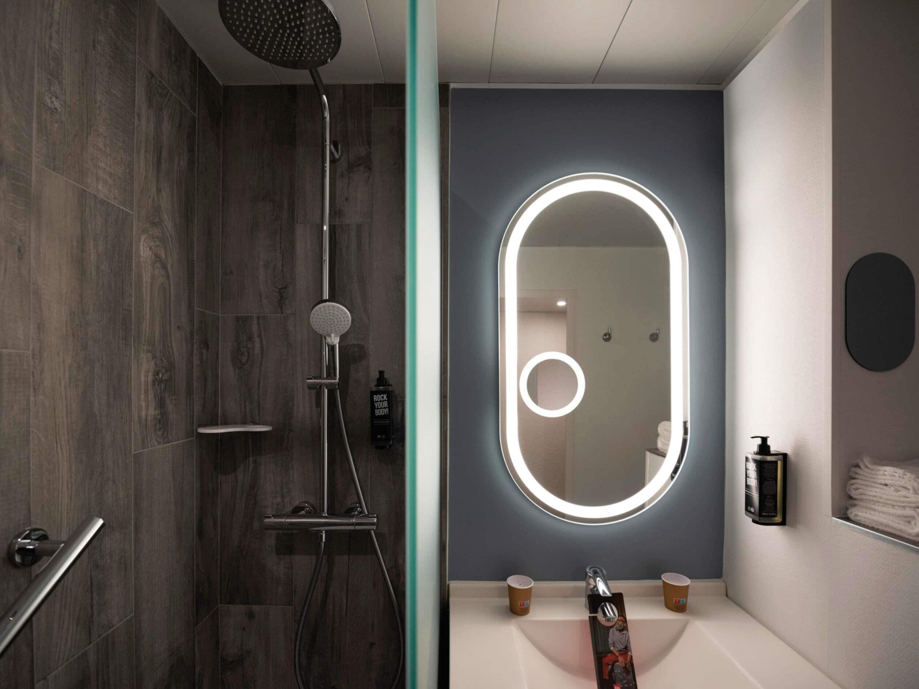 A modern bathroom with a shower, a vanity with a mirror, and a towel rack.