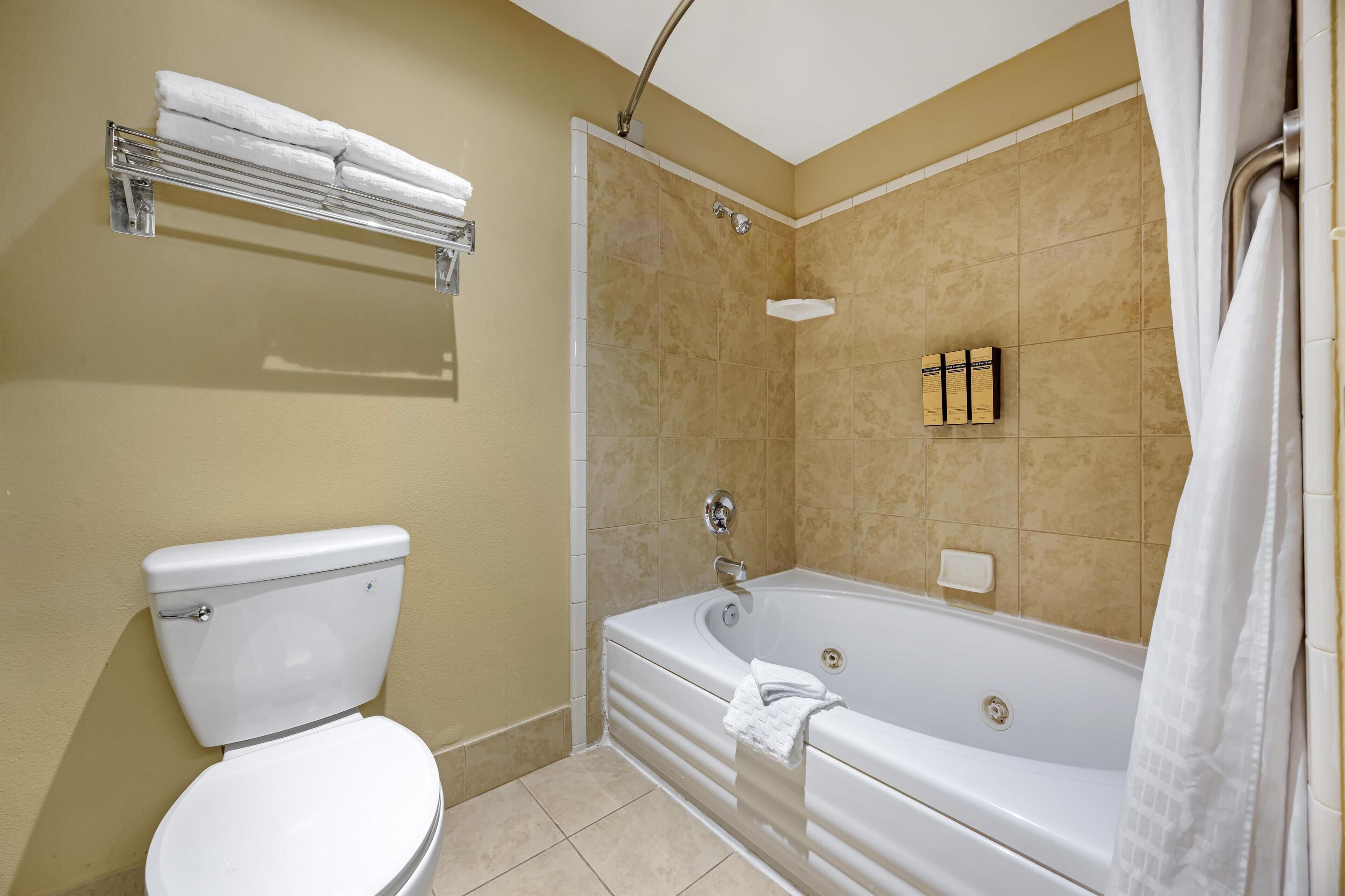 suite, 2 queen beds, non smoking, jetted tub (with sofabed) | bathroom | combined shower/bathtub, free toiletries, hair dryer, towels