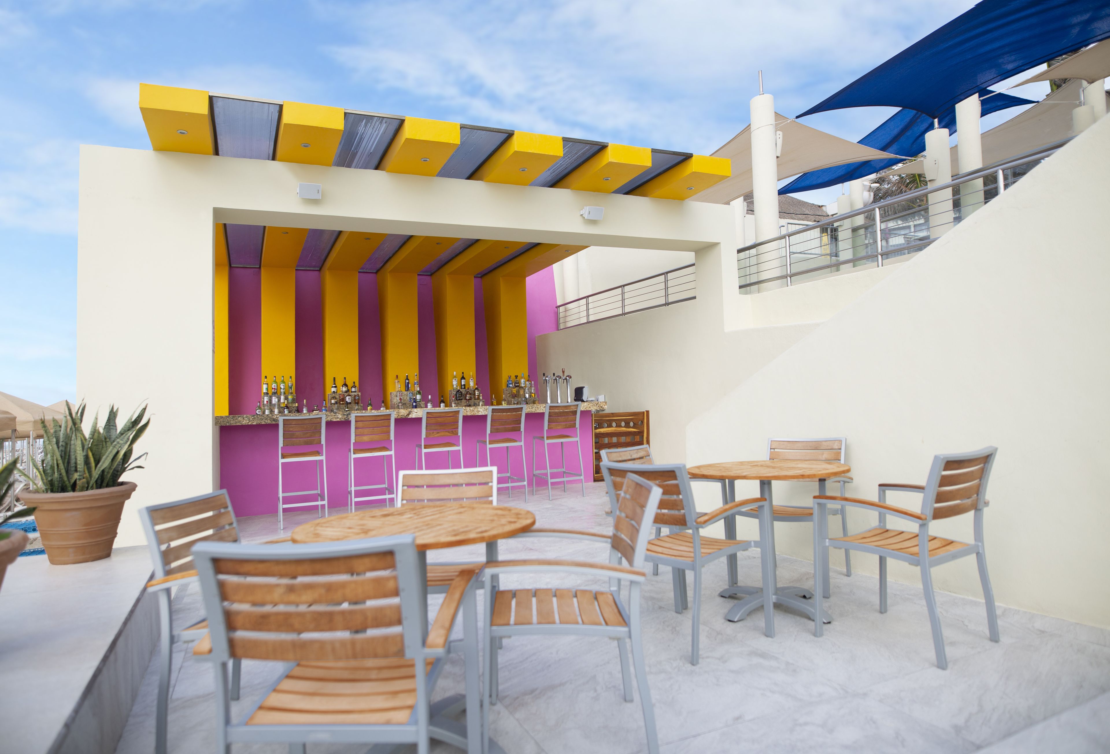 An outdoor bar area with multiple seating options and a bar counter.