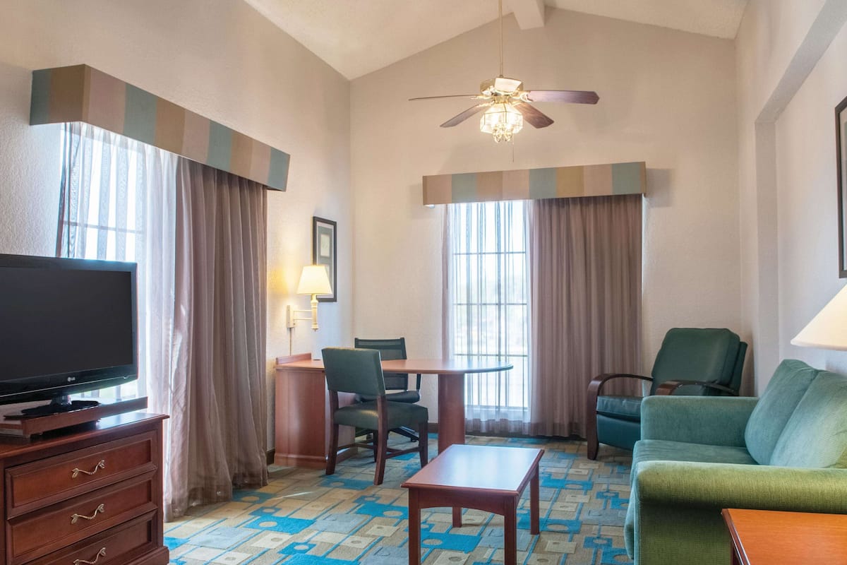 deluxe suite, 1 king bed, non smoking | premium bedding, desk, laptop workspace, iron/ironing board