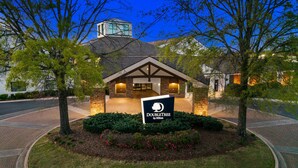 A hotel entrance with a sign reading "DOUBLETREE by Hilton".