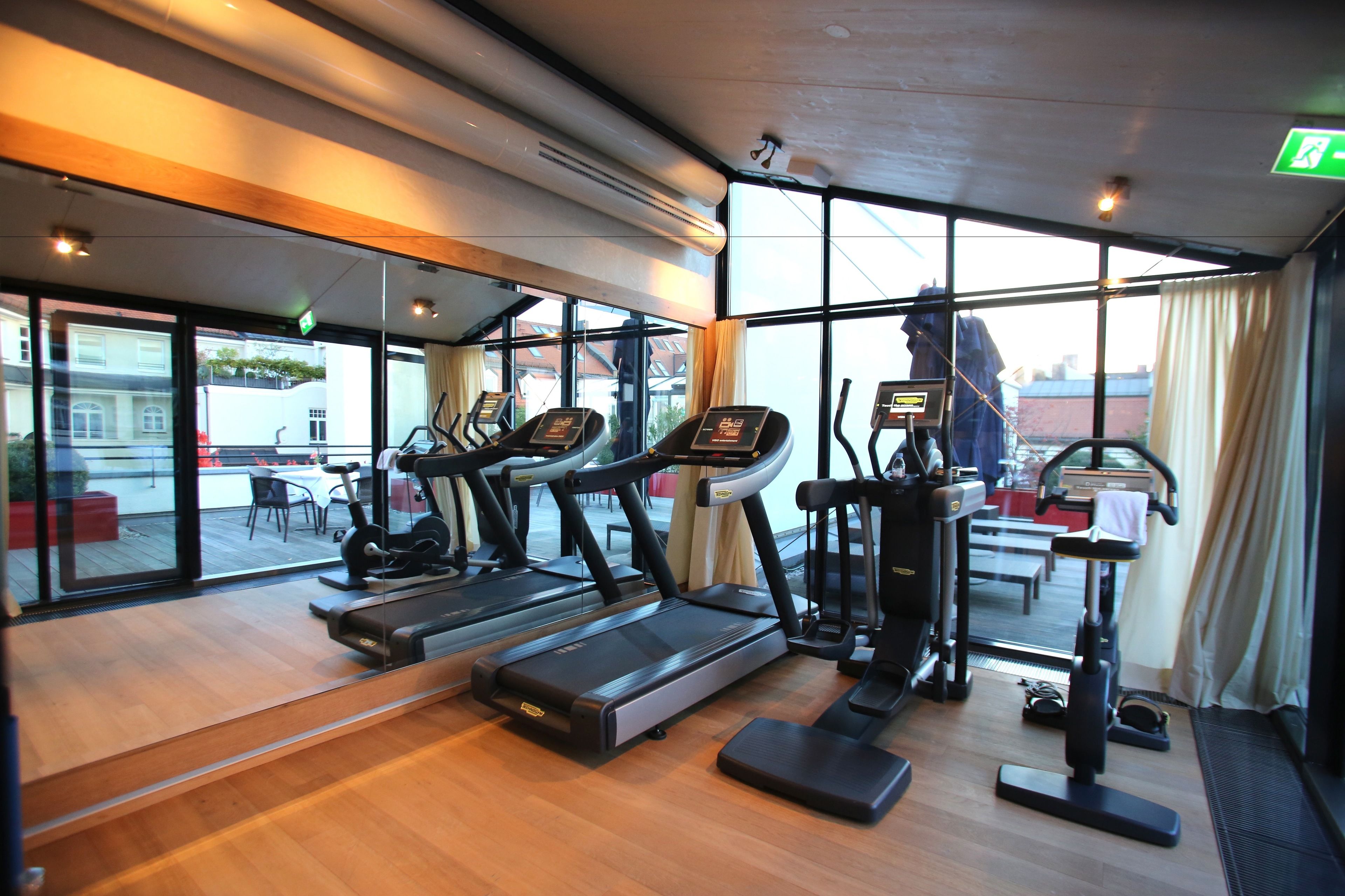 A gym with treadmills, elliptical machines, and a rowing machine.