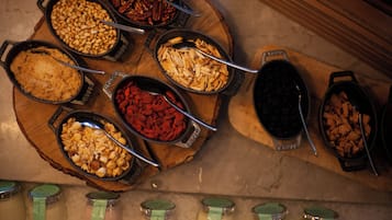 A buffet with various food items and condiments.