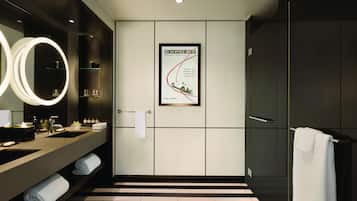 Bathroom features a large mirror, two sinks, and a striped floor.
