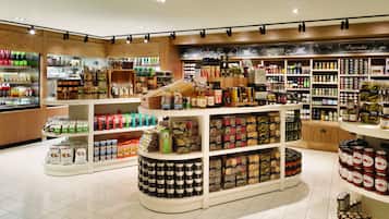 A well-organized store with shelves stocked with various food items, condiments, and packaged goods.
