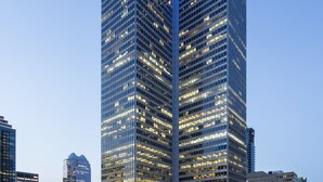 A modern high-rise building with a glass facade and illuminated blue lights. - Fairmont The Queen Elizabeth (Montreal)