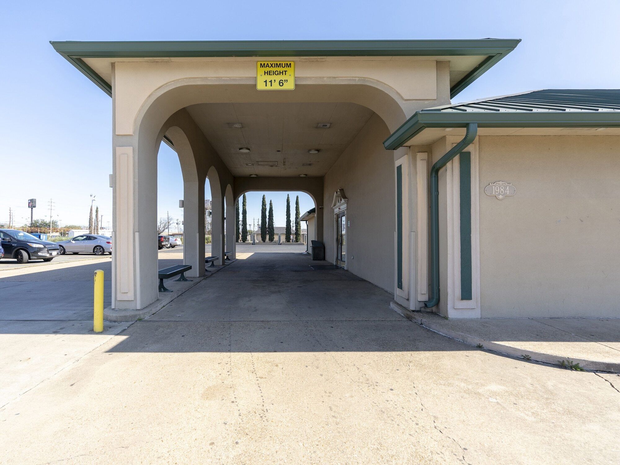 A covered parking area with a maximum height sign of 11'6".