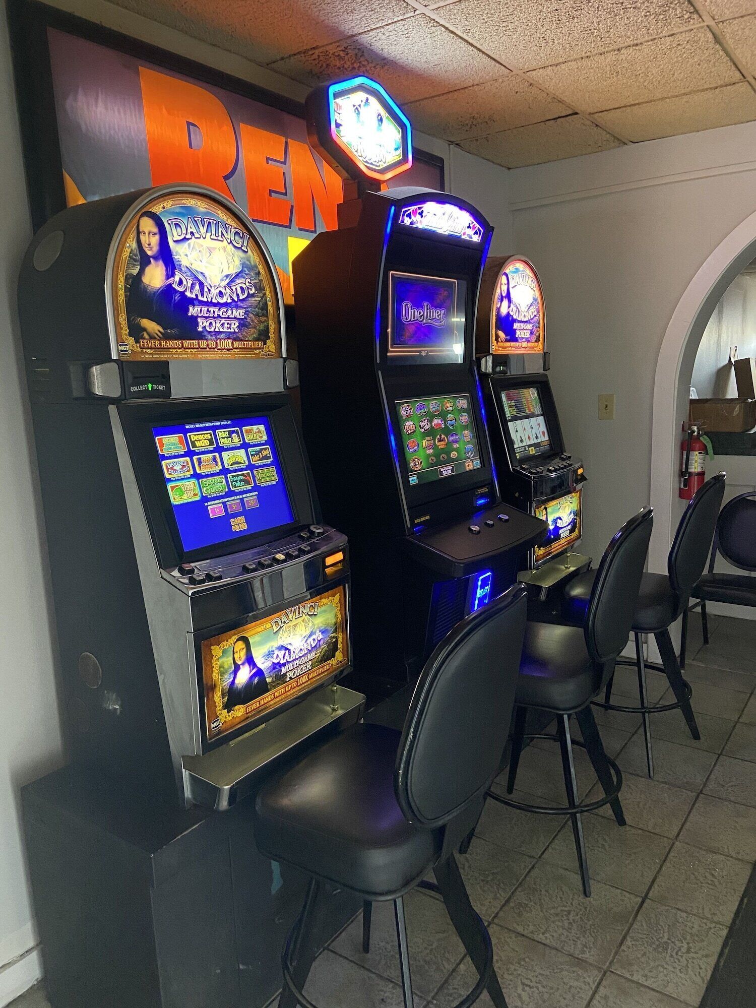 A row of slot machines with a 'REN' sign above them.