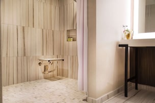 Een badkamer met een houten wand, een wastafel en een spiegel.