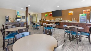 A modern cafe with multiple seating areas, a coffee machine, and a beverage dispenser.