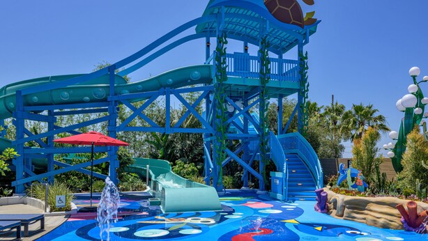 A water park with a blue roller coaster, slides, and a turtle-themed structure. - Pixar Place Hotel (Anaheim)