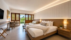 A modern bedroom with a large bed, a desk, and a balcony. - Copamarina Beach Resort & Spa (Guanica)