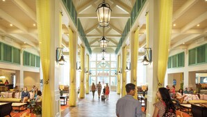 A spacious lobby with high ceilings, large windows, and a central walkway. - Disney's Caribbean Beach Resort (Lake Buena Vista)