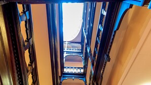 A wooden staircase with ornate railings leading to a balcony. - Nottingham City Centre by Sunday (Nottingham)