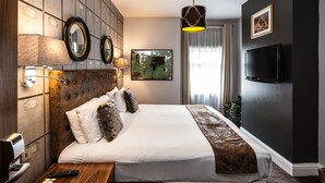 A hotel room with a large bed, two wall-mounted mirrors, a flat-screen TV, a painting on the wall, and a window with curtains. - Nottingham City Centre by Sunday (Nottingham)