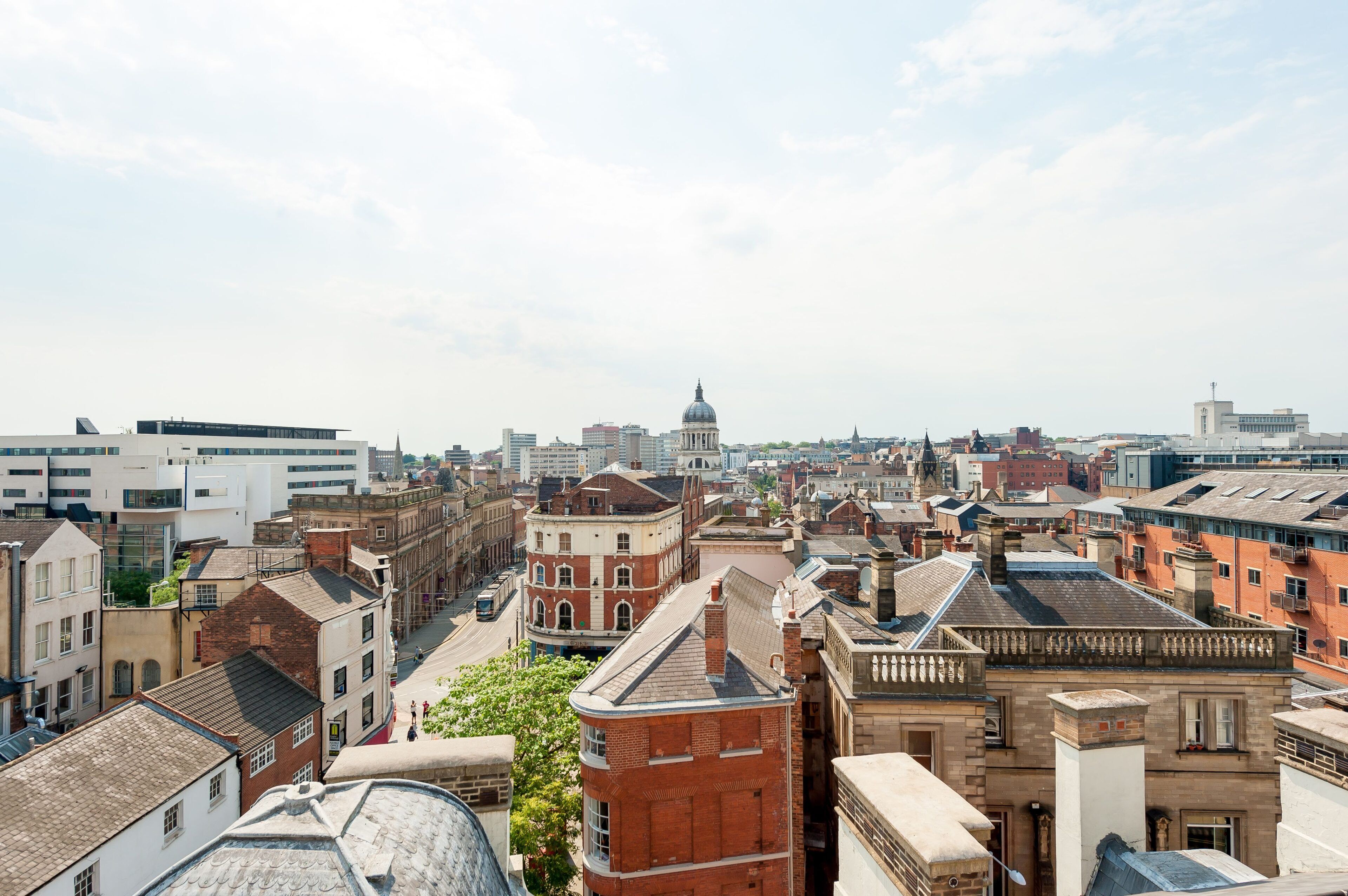 A cityscape with a mix of modern and historic buildings, including a prominent dome structure.