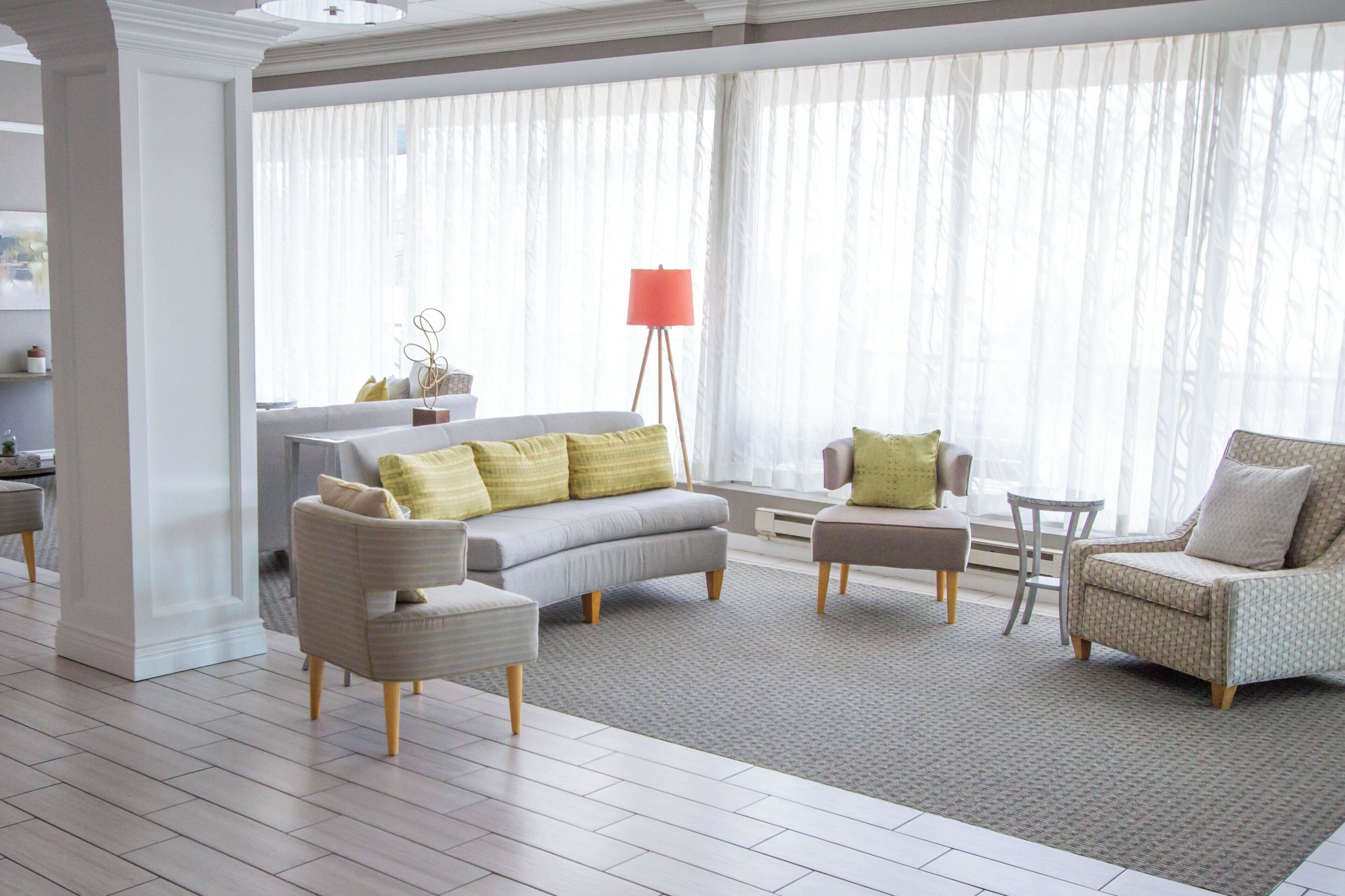 A modern living room with a sofa, armchairs, and a coffee table.