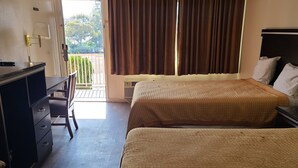 A hotel room with two beds, a desk, and a chair. - Relax Inn And Suites (El Cajon)