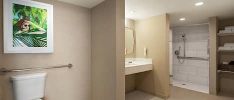 A modern bathroom with a toilet, sink, and shower area.