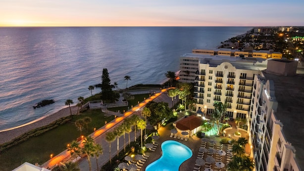 Un resort con piscina, playa y vista al océano.