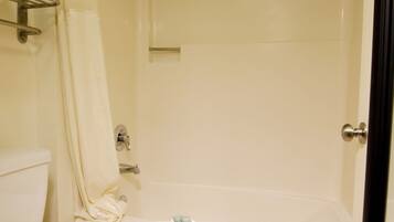 A bathroom with a toilet, a shower, and a bathtub.